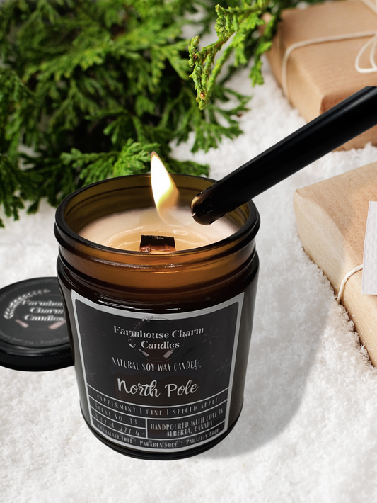 If you're longing for a trip to the North Pole, we have the next best thing. Our North Pole Soy Candle captures the refreshing essence of the winter outdoors. This candle is a perfect blend of green pine trees, refreshing peppermint, sweet and crisp apples, and a touch of spicy cinnamon. It gives off the perfect scent that will transport you to a winter wonderland while making you feel cozy and warm. www.farmhousecharmcandles.com