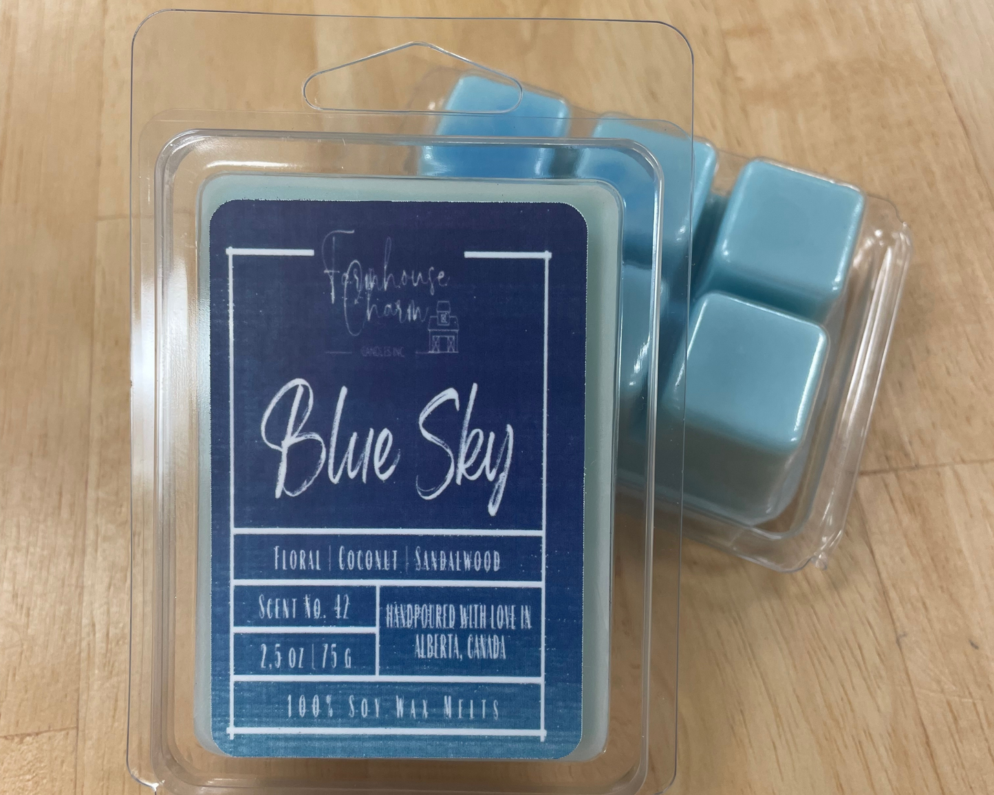 Blue Sky Soy Wax Melts- Farmhouse Charm has a delightful blend of floral, coconut, and sandalwood scents that will fill your home with a calming atmosphere. Floral notes of fresh flowers and green botanicals create a soothing and inviting atmosphere, while the coconut and sandalwood create a warm and comforting ambience. Together, these  scents combine to create an atmosphere that evoke the feeling of a bright and sunny spring day!  size: 2.5 oz. (75 g)