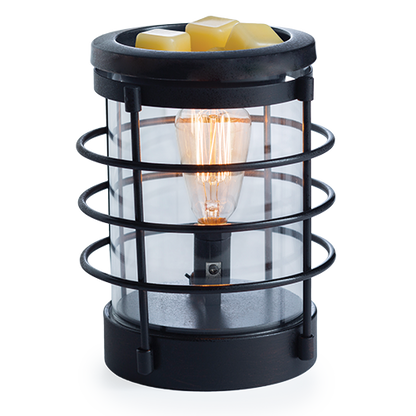 An updated traditional style with wire framing in a matte black finish give this Vintage Bulb Illumination a classic lantern feel. Illumination Fragrance Warmers use a Vintage Bulb to warm wax melts in the dish, releasing their fragrance.   Suggested Use: Simply add wax melts to the dish, turn it on, and enjoy your favorite fragrance as it spreads through the room. This warmer works beautifully with 100% Soy Wax Melts by Farmhouse Charm Candles Inc.