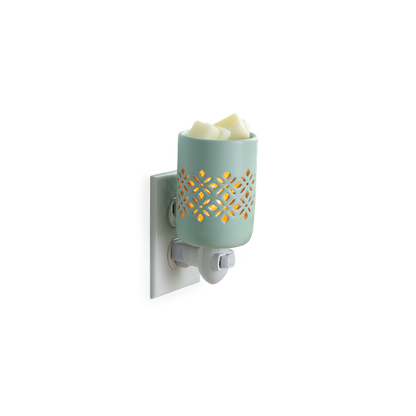 A precision cut pattern allows the light to be the focal point of a soft matte finish in a refreshing mint glaze. Pluggable Fragrance Warmers can be used in both vertical and horizontal outlets by twisting the plug base, making them ideal above counter outlets in small rooms and spaces.  Suggested Use: Simply add wax melts to the dish, turn it on, and enjoy your favorite fragrance as it spreads through the room. This warmer works beautifully with 100% Soy Wax Melts by Farmhouse Charm Candles Inc