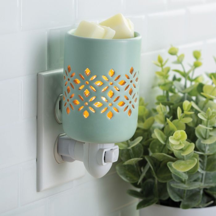 A precision cut pattern allows the light to be the focal point of a soft matte finish in a refreshing mint glaze. Pluggable Fragrance Warmers can be used in both vertical and horizontal outlets by twisting the plug base, making them ideal above counter outlets in small rooms and spaces.  Suggested Use: Simply add wax melts to the dish, turn it on, and enjoy your favorite fragrance as it spreads through the room. This warmer works beautifully with 100% Soy Wax Melts by Farmhouse Charm Candles Inc