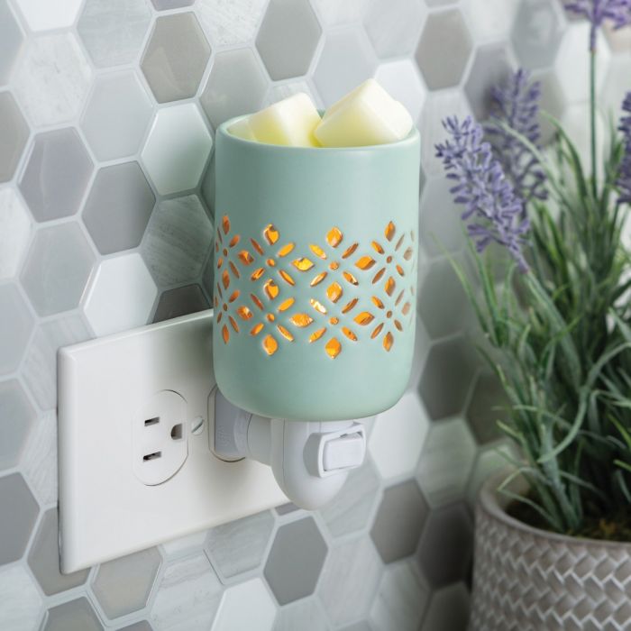 A precision cut pattern allows the light to be the focal point of a soft matte finish in a refreshing mint glaze. Pluggable Fragrance Warmers can be used in both vertical and horizontal outlets by twisting the plug base, making them ideal above counter outlets in small rooms and spaces.  Suggested Use: Simply add wax melts to the dish, turn it on, and enjoy your favorite fragrance as it spreads through the room. This warmer works beautifully with 100% Soy Wax Melts by Farmhouse Charm Candles Inc